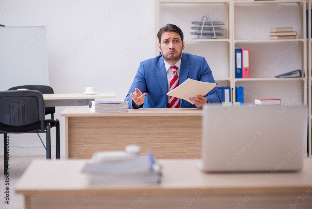 Young attractive employee working in the office