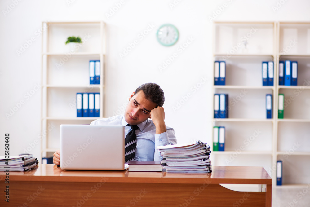 Young male employee working at workplace Young male employee working at workplace