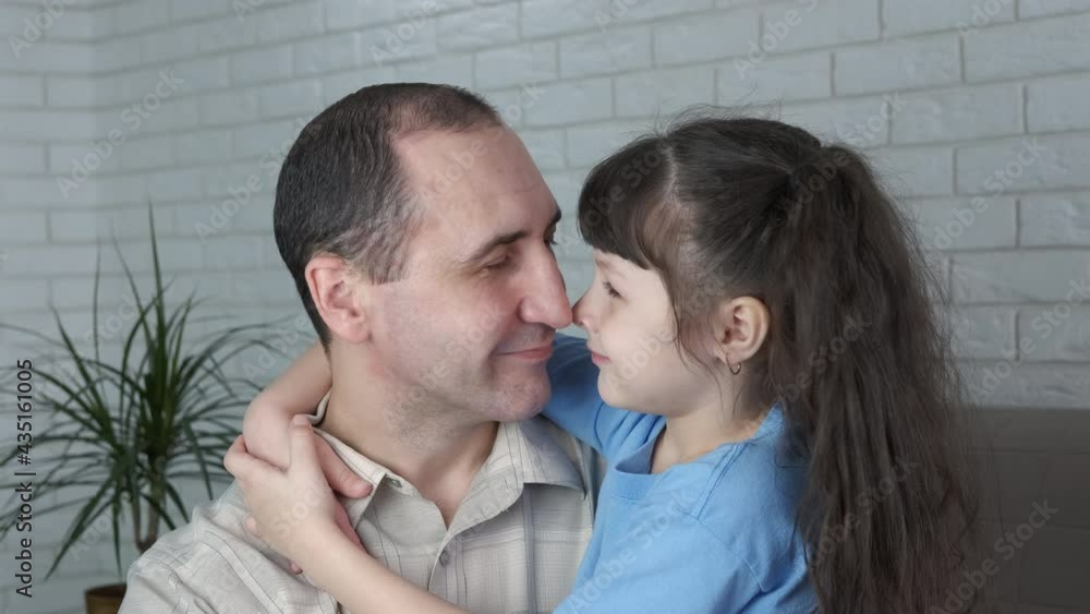 Daughter enjoy father time. A happy daughter with love embrace her father at home. Daughter enjoy father time. A happy daughter with love embrace her father at home.