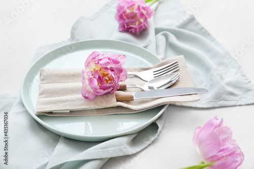 Beautiful table setting with flowers on white background, closeup