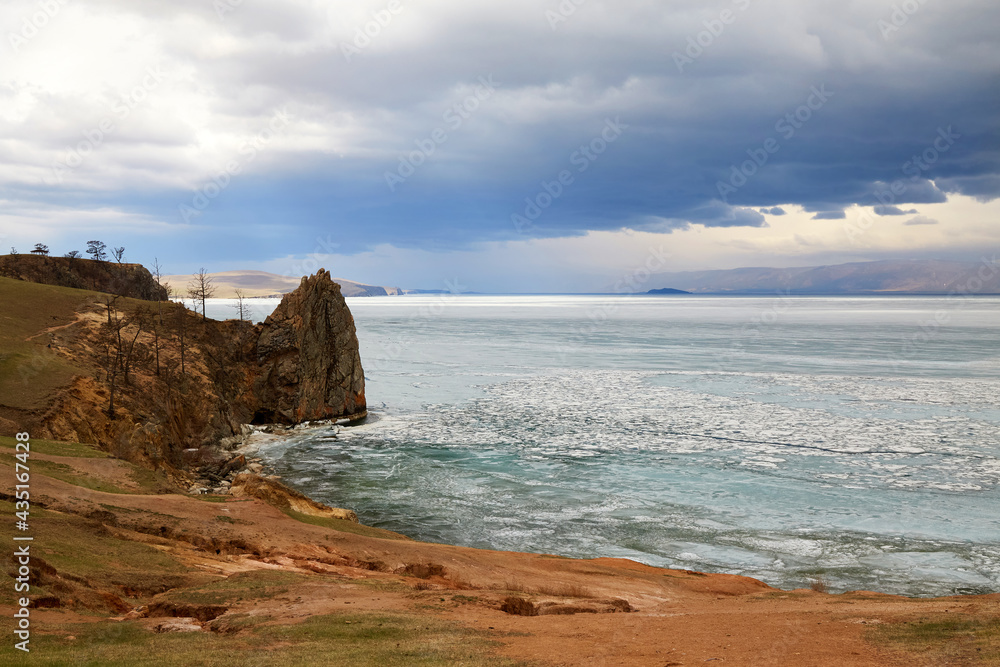 Cape Bogatyr on a cloudy spring day, Olkhon Island. Lake Baikal during the melting of the ice.