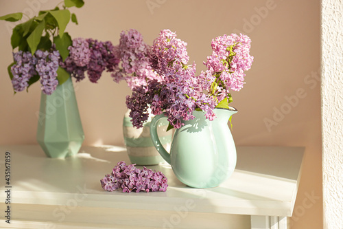 Wallpaper Mural Vases with beautiful lilac flowers on table in room Torontodigital.ca
