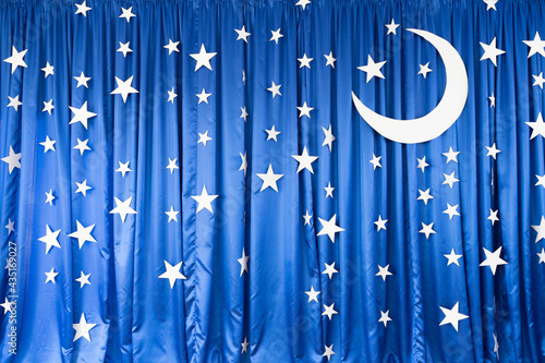 Blue background from matter with white stars and moon
