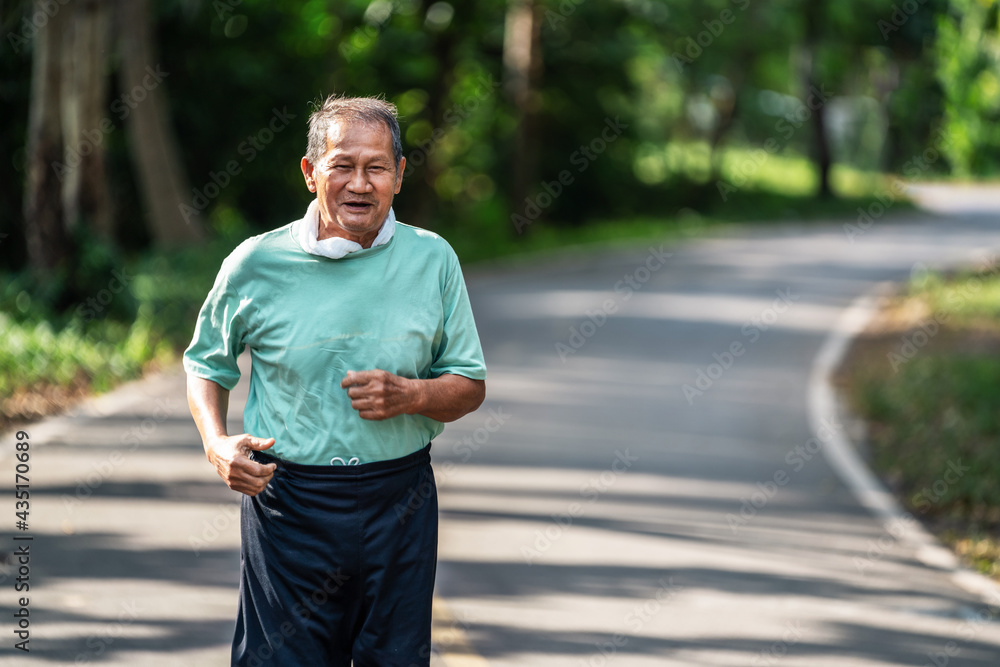 Asian senior mature man running jogging in park for good health. Asian senior mature man running jogging in park for good health.