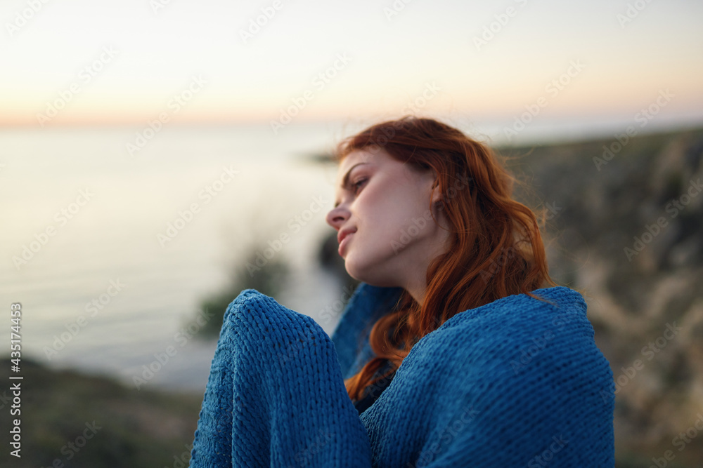 pretty woman in the mountains outdoors covered herself with a blanket coolness traveling pretty woman in the mountains outdoors covered herself with a blanket coolness traveling