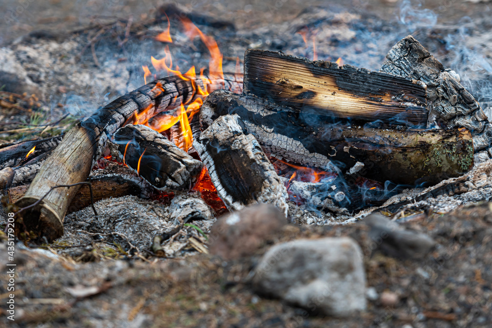 burning log of wood close-up as abstract background, the hot embers of burning wood log fire burning log of wood close-up as abstract background, the hot embers of burning wood log fire