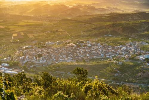Elevated view of a town at golden hour surrounded by vineyards. La Font de la Figuera, Valencia, Spain