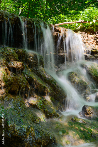 Fototapeta Naklejka Na Ścianę i Meble -  Forest small waterfall on a sunny summer day