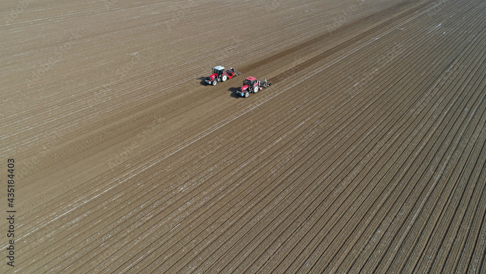 Farmers drive planters to plant Plastic Mulched peanuts in North China