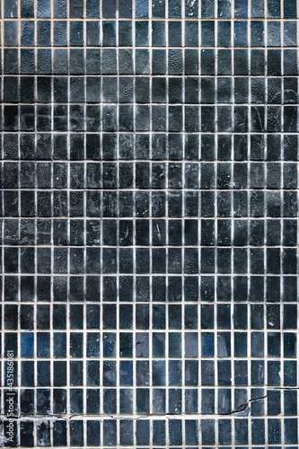 texture of small facade ceramic black tiles, vertical format