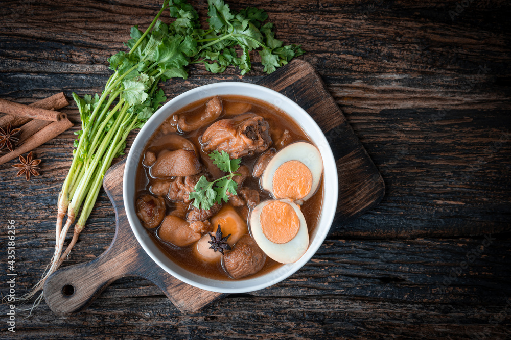 Food of thailand Pig, stewed eggs in white bowl on black background. Food of thailand Pig, stewed eggs in white bowl on black background.