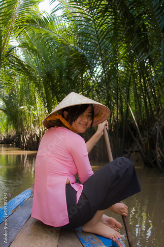 Arm of the Mekong Delta,woman in traditional rowing boat, Can Tho, Mekong Delta, Vietnam, Southeast Asia photo