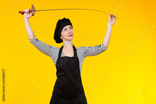 Tablou pe pânză Girl with a rapier on orange background