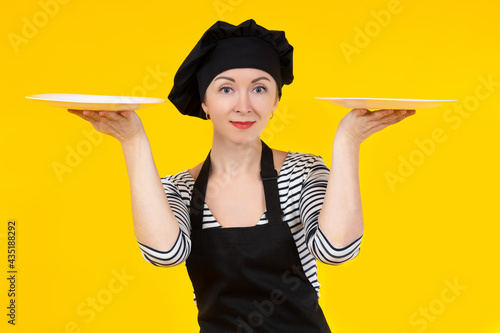 Female chef holds two plate...
