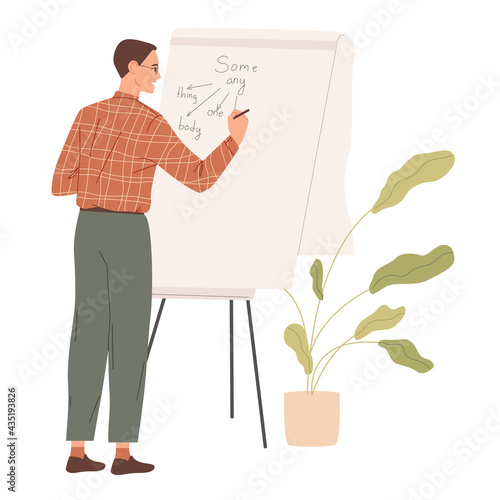 Male teacher wtiting on board in school classroom.