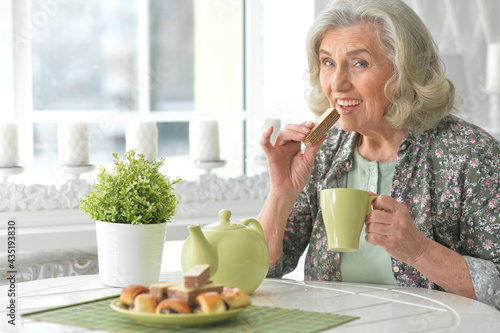 Beautiful smiling senior woman drinking tea