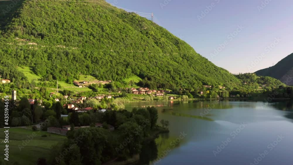 Drone flying over Lake Endine, Lombardy, Italy. Aerial view of charming Italian villages seen from the sky, with the mountains in the background Drone flying over Lake Endine, Lombardy, Italy. Aerial view of charming Italian villages seen from the sky, with the mountains in the background