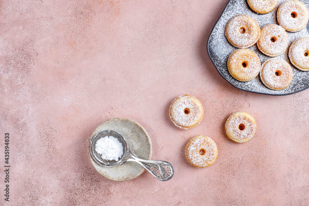 Homemade mini donuts with powdered sugar. Homemade mini donuts with powdered sugar.