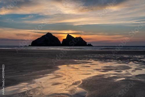 Absolutely beautiful landscape images of Holywell Bay beach in Cornwall UK during golden hojur sunset in Spring