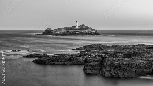 Beautiful and unusual landscape image of landmark Godrevy lighthouse on Cornwall's coastline