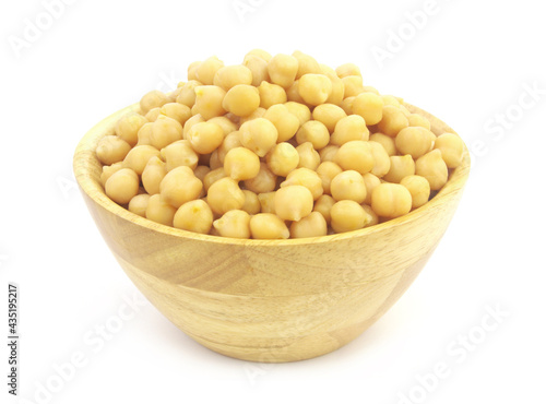 Chickpeas in natural wooden bowl isolated on white background