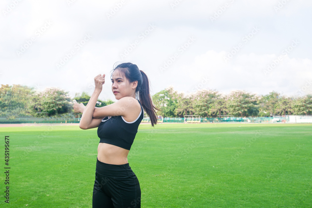 Portrait of beautiful young woman exercising on green grass. female fitness model stretching exercise or warming up before work out. exercise, Fitness, workout, sport, lifestyle concept. Portrait of beautiful young woman exercising on green grass. female fitness model stretching exercise or warming up before work out. exercise, Fitness, workout, sport, lifestyle concept.