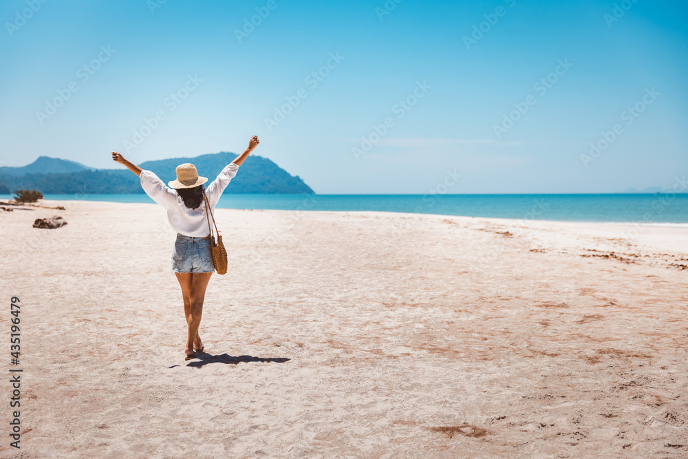 Traveler asian woman relax and travel on beach in Thailand Traveler asian woman relax and travel on beach in Thailand