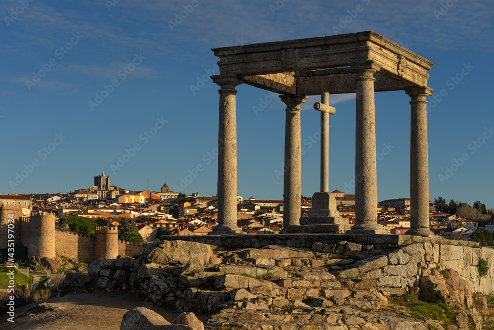 Walls of the city of Avila (World Heritage Site by UNESCO) and Cuatro Postes lookout monument at sunset. Castilla y Leon. Spain.