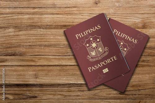 A Philippine passport is both a travel document and a primary national identity document issued to citizens of the Philippines ,Two passports on a wooden floor
