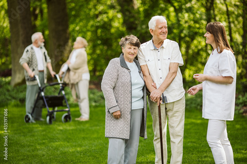 Elder people with the caregiver in the garden
