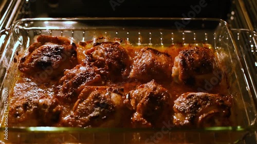 Close-up of baking hot grill chicken legs in oven. Poast chicken meat close-up. Grill chicken wings in the oven with grain processed. Motion. Footage.