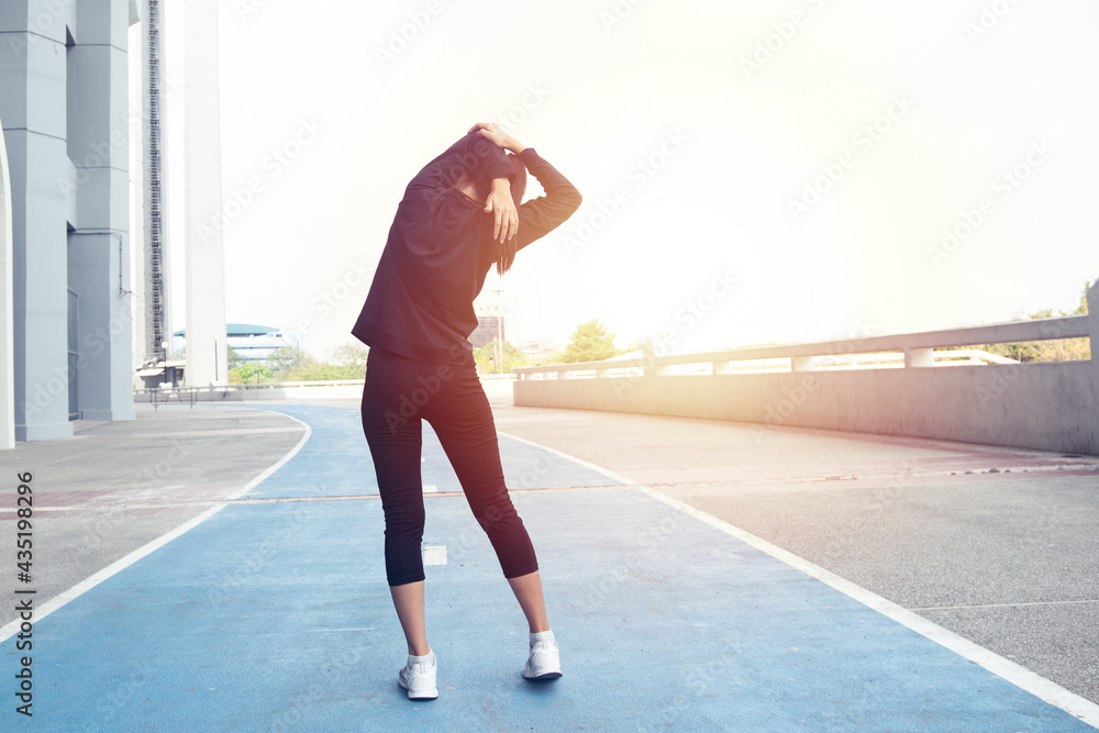 Back of Full body woman exercising on Running Track. female fitness model stretching exercise or warming up before work out. exercise, Fitness, workout, sport, lifestyle concept. Healthy concept. Back of Full body woman exercising on Running Track. female fitness model stretching exercise or warming up before work out. exercise, Fitness, workout, sport, lifestyle concept. Healthy concept.