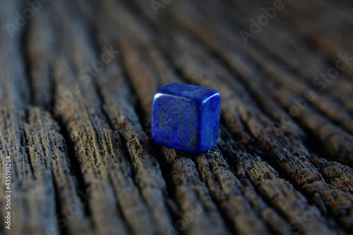 Lapis Is a beautiful natural gemstone on a wooden floor 