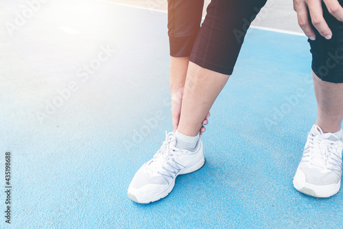 Close up Ankle Injury accident between exercise running and jogging on running track. Overtrained injured between trainning. twist sprain and cramp or injury accident concept. body ache concept.