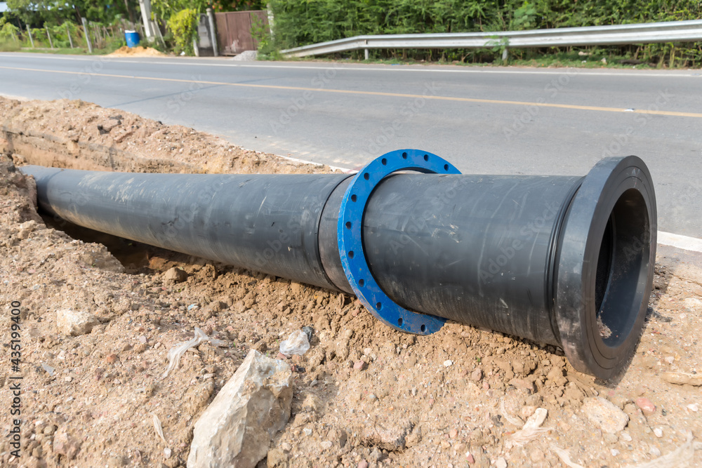 Construction site with new Water Pipes in the ground. sewer pipes to repair or restore in street city Construction site with new Water Pipes in the ground. sewer pipes to repair or restore in street city