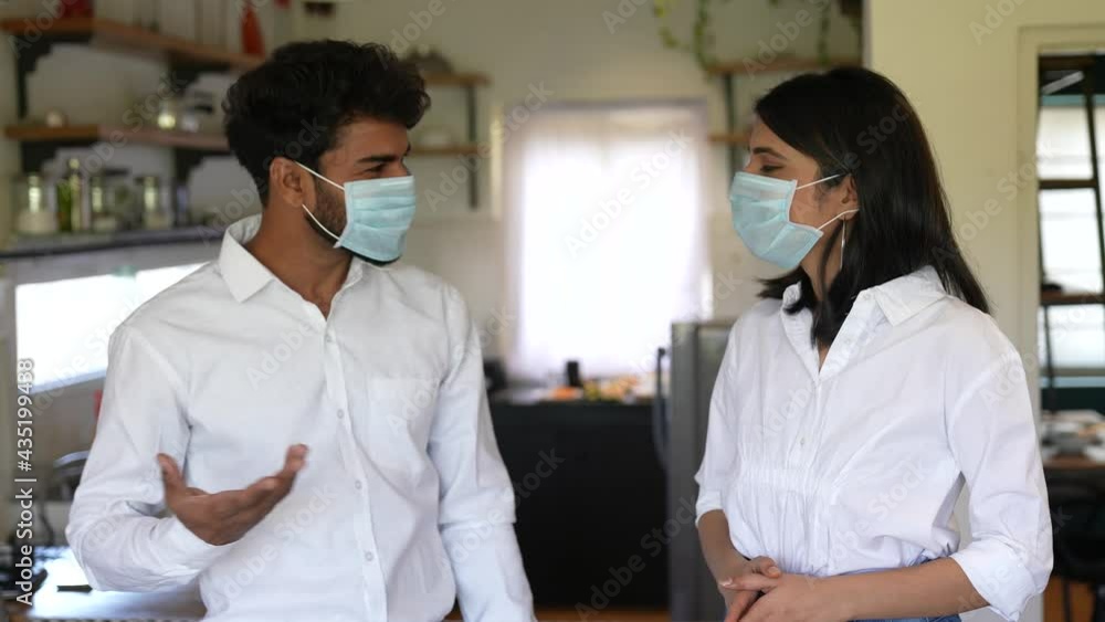 Asian man and woman,couple wear face mask greeting with elbow bump in modern kitchen at home.lifestyle concept.Employee avoid touch for corona virus prevention.corona virus protection concept. Asian man and woman,couple wear face mask greeting with elbow bump in modern kitchen at home.lifestyle concept.Employee avoid touch for corona virus prevention.corona virus protection concept.
