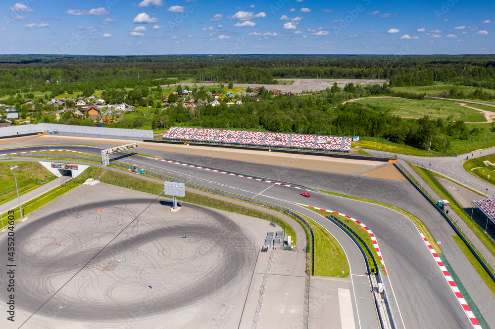 a panoramic view of the avodrome for racing in sports cars before the races on a sunny day filmed from a drone 