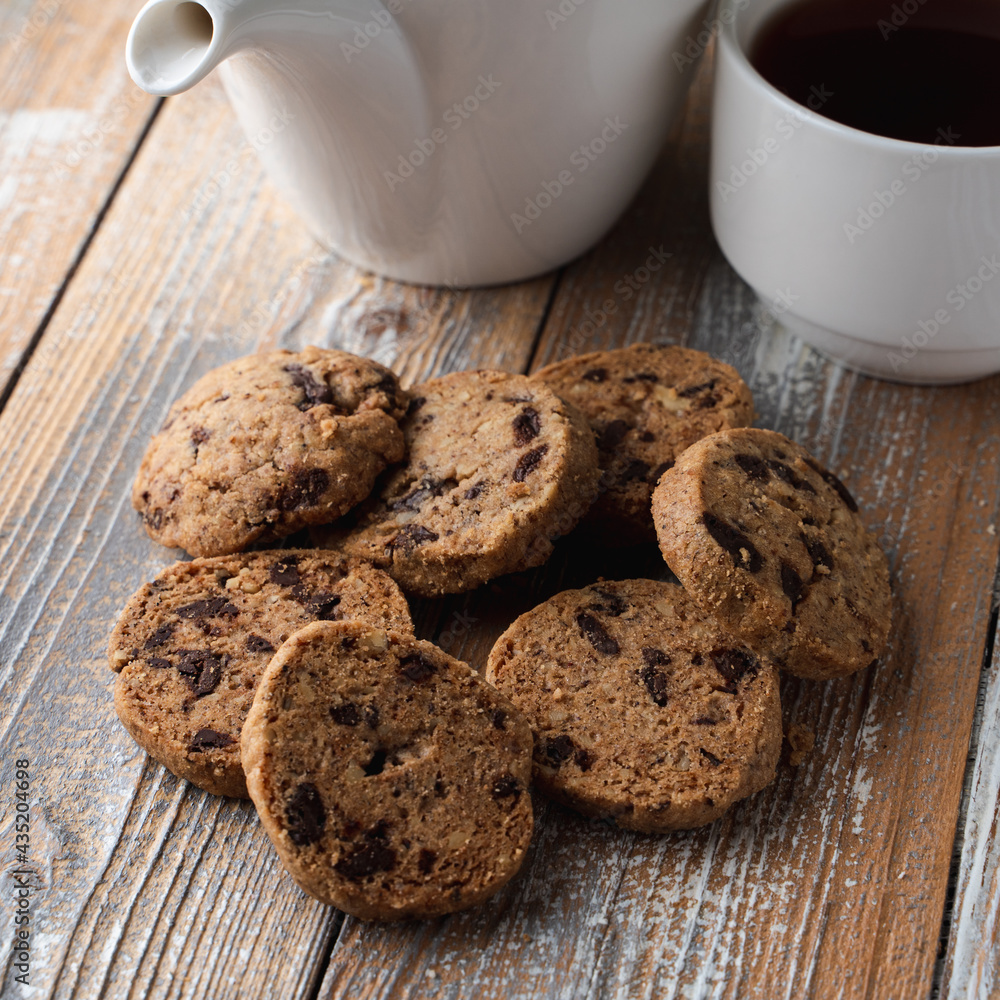A pile of chocolate chip cookies on a wooden rustic table A pile of chocolate chip cookies on a wooden rustic table
