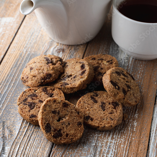 A pile of chocolate chip cookies on a wooden rustic table