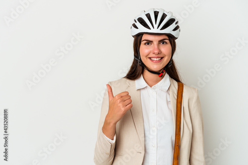 Young caucasian woman riding a bicycle to work isolated on white background smiling and raising thumb up