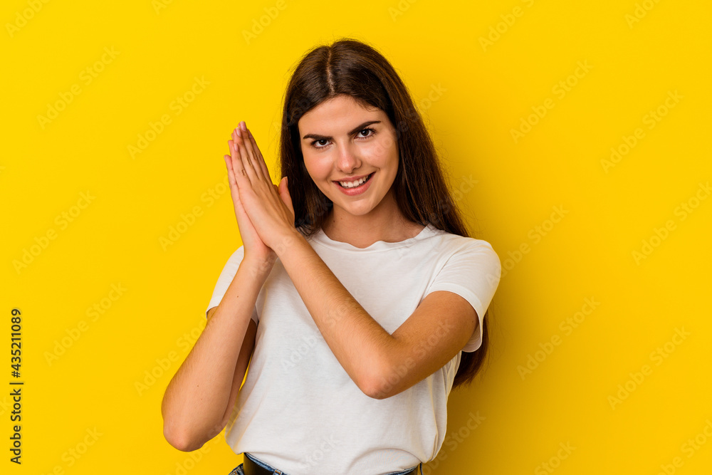 Young caucasian woman isolated on yellow background feeling energetic and comfortable, rubbing hands confident. Young caucasian woman isolated on yellow background feeling energetic and comfortable, rubbing hands confident.