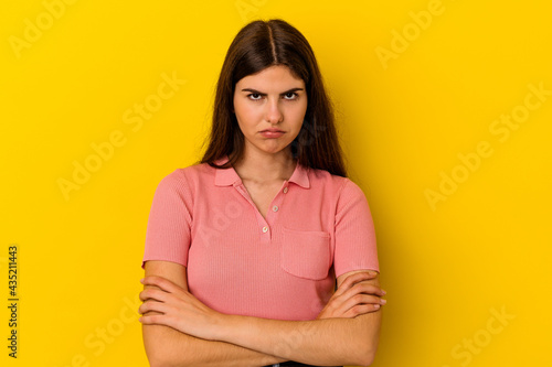 Young caucasian woman isolated on yellow background blows cheeks, has tired expression. Facial expression concept.