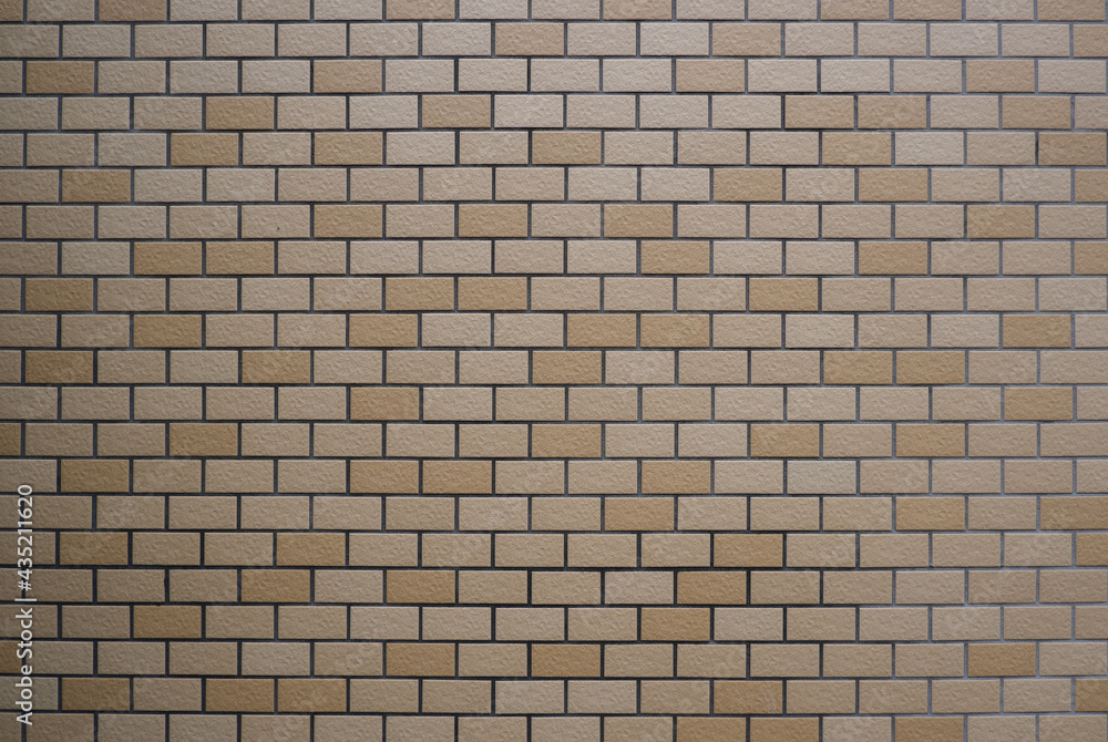 Light Brown tiled wall. Brick wall material for vintage, retro design and background. Interior, exterior, surface material. Light Brown tiled wall. Brick wall material for vintage, retro design and background. Interior, exterior, surface material.