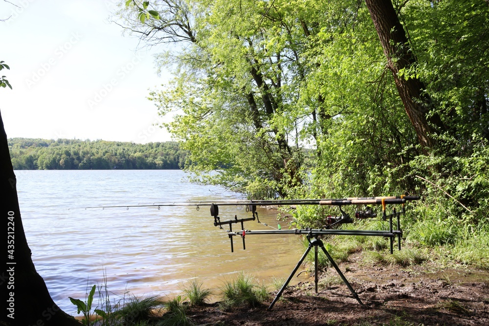 Fishing hobby. Fishing rods on a stand by the lake. Fishing stand with fishing rods by the water.