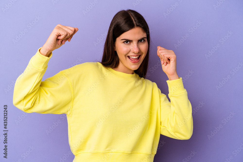 Young caucasian woman isolated on purple background dancing and having fun. Young caucasian woman isolated on purple background dancing and having fun.
