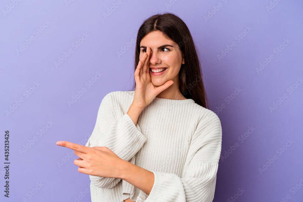 Young caucasian woman isolated on purple background saying a gossip, pointing to side reporting something. Young caucasian woman isolated on purple background saying a gossip, pointing to side reporting something.