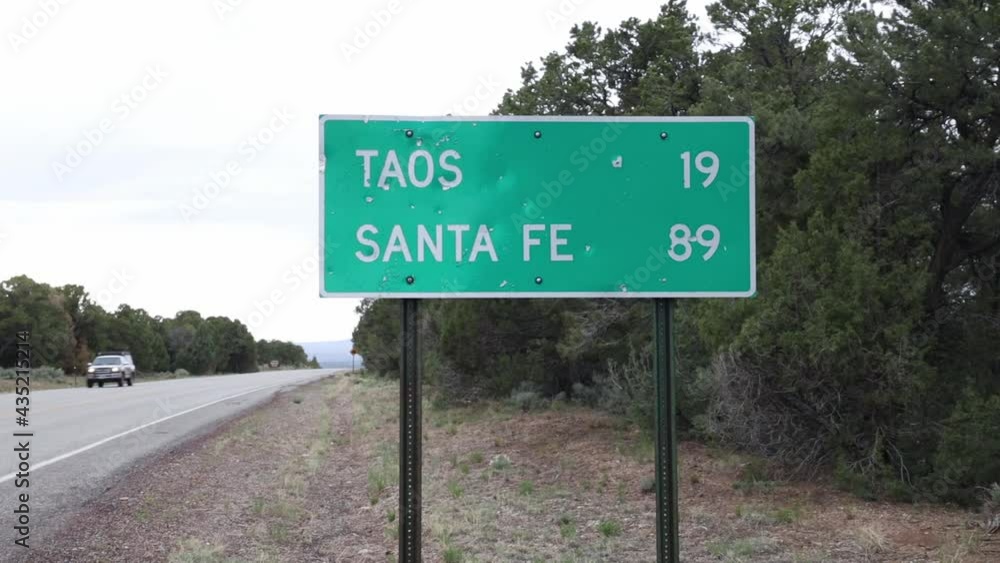 highway sign showing 19 miles to Taos, 89 miles to Santa Fe New Mexico highway sign showing 19 miles to Taos, 89 miles to Santa Fe New Mexico