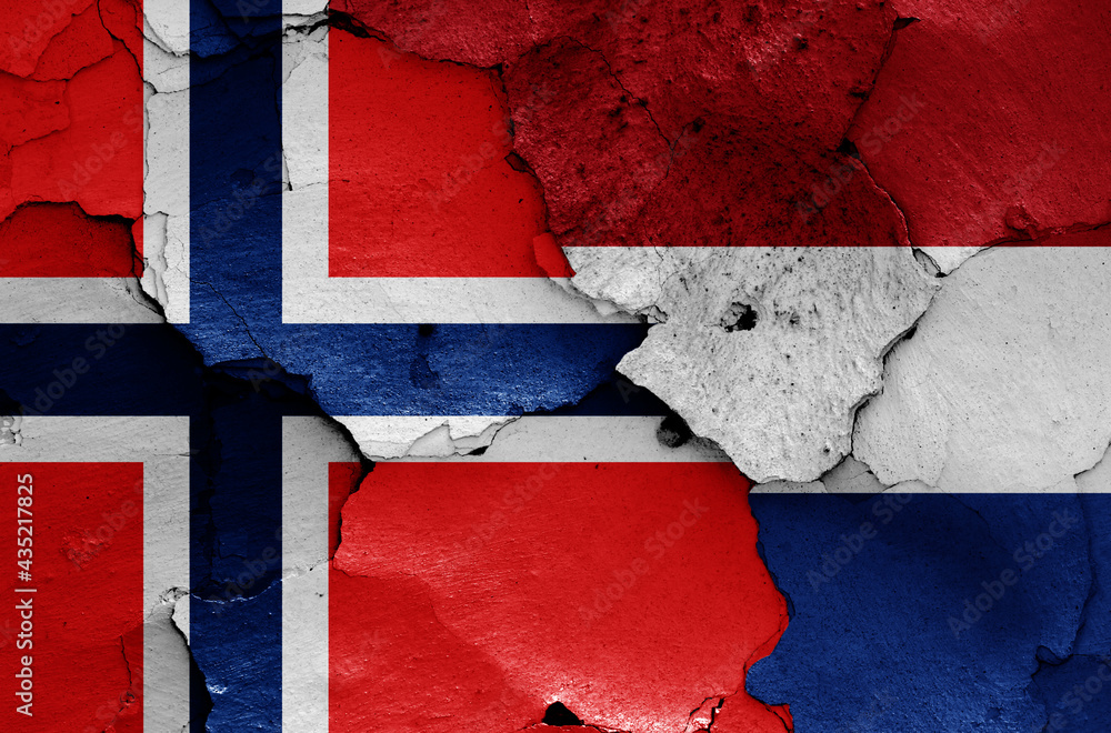 flags of Norway and Netherlands painted on cracked wall