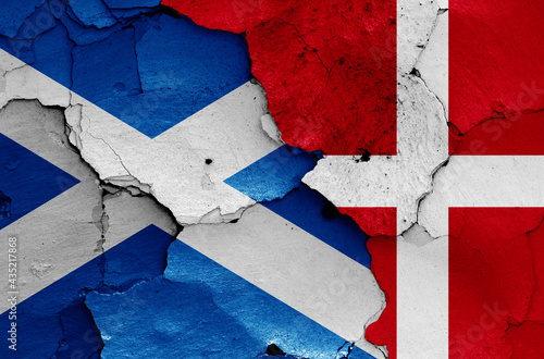 flags of Scotland and Denmark painted on cracked wall