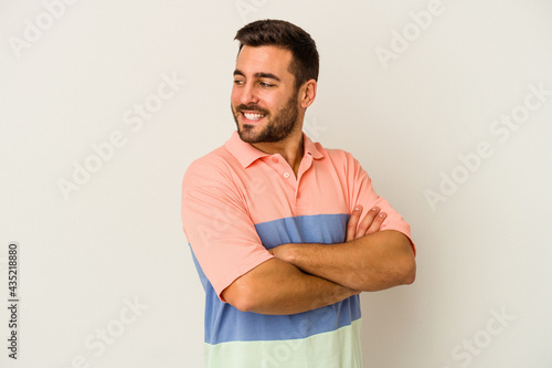 Young caucasian man isolated on white background laughing and having fun.